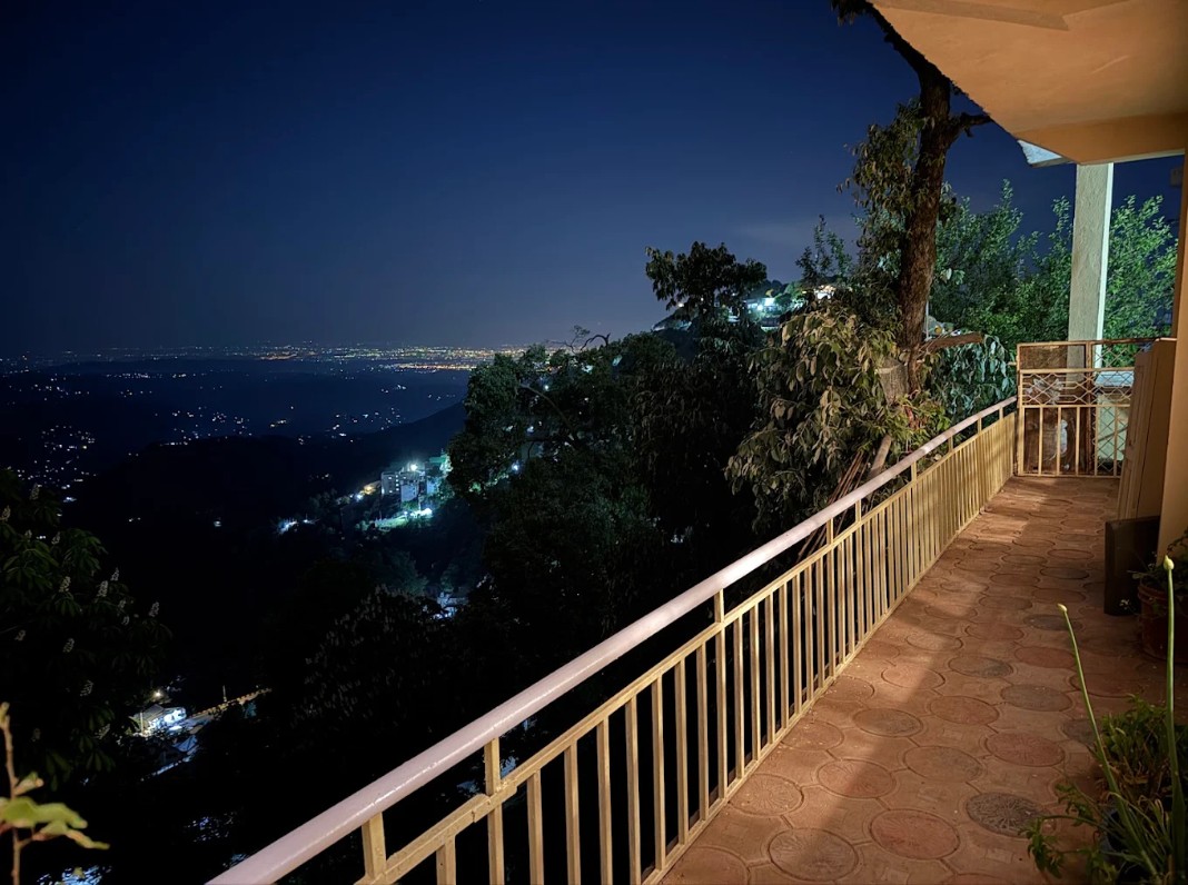 Private balcony at Mehtab Lodges overlooking the Murree valley at night